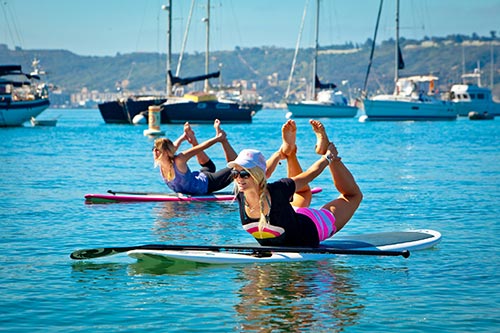 yoga stand up paddle boat-group exersize on a stand up paddle boat
