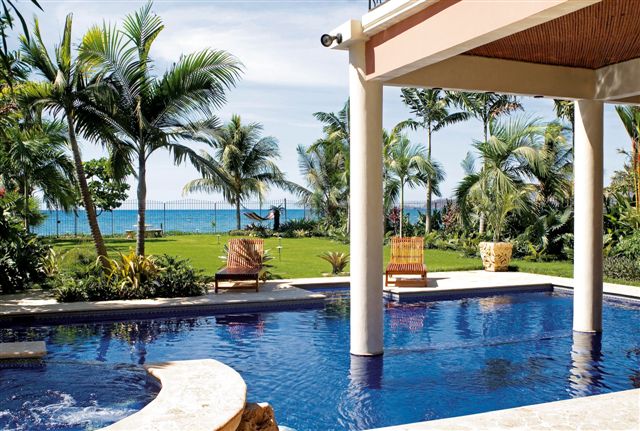 This resort-style luxury villa is right on Playa Flamingo and has a beautiful tropical backyard leafing to the beach. 