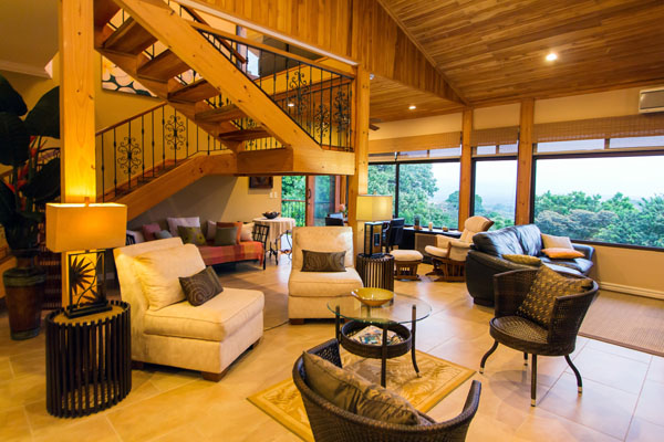 The large living area is a great entertaining space with high wooden ceilings and comfortable luxury seating.