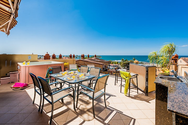 The private terrace of this luxury penthouse offers sun, shade, dining, lounging, hot tub, and stunning views.