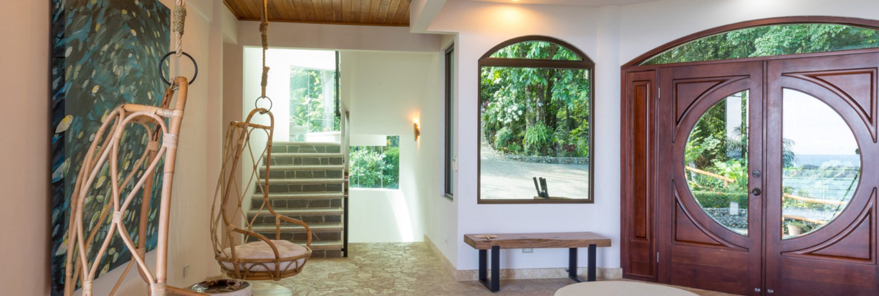 The beautiful entrance to the villa has a natural stone floor and some unique and comfy seats for lounging.
