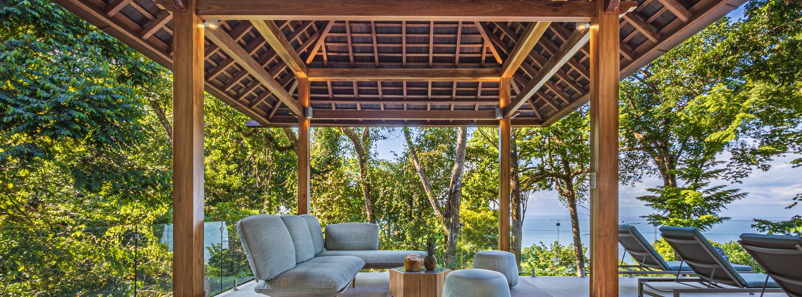 Discover tranquility and enjoy sweeping views of the Pacific in this modern cozy gazebo and sitting area by the pool.